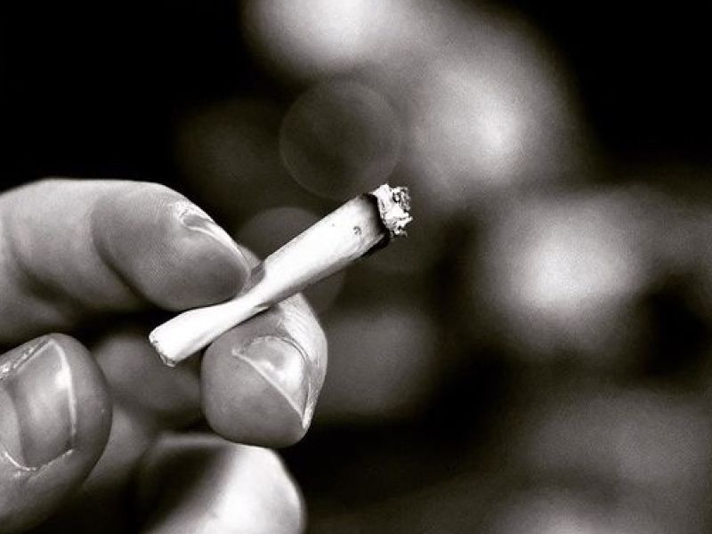Having a smoke late at night in a bar.